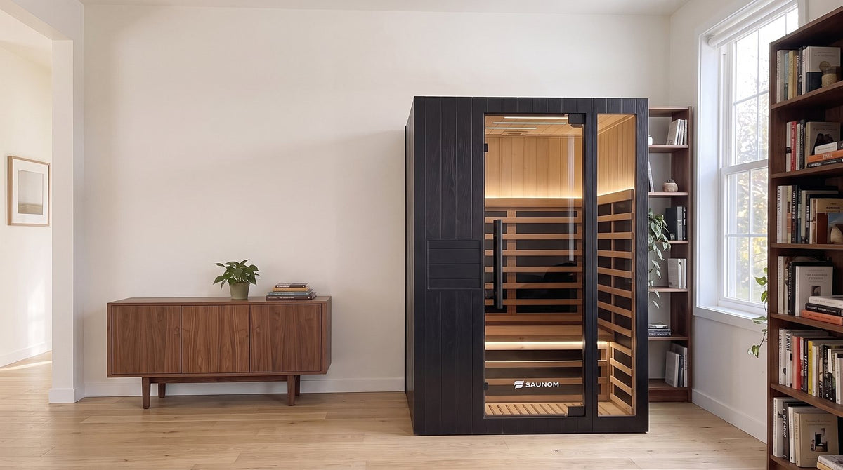 Black Saunom infrared sauna in a living room next to a walnut sideboard