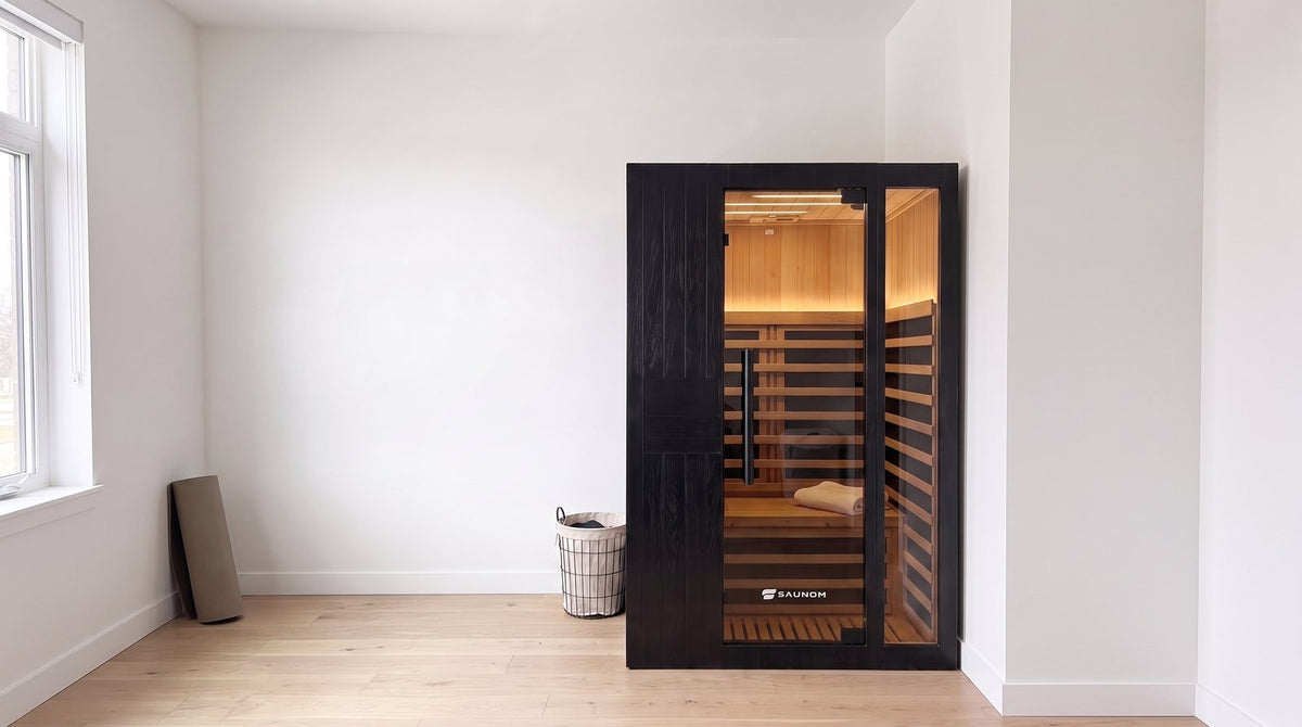 Black Saunom infrared sauna with the door closed in a bright spare room