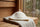 A cream wool Havu sauna hat laid flat on a linen towel to dry, the correct way to dry a wool sauna hat.