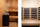 Side-by-side comparison of a traditional Finnish sauna with a stone-filled heater and steam on the left and an infrared sauna cabin with carbon heater panels behind wood slat guards on the right.