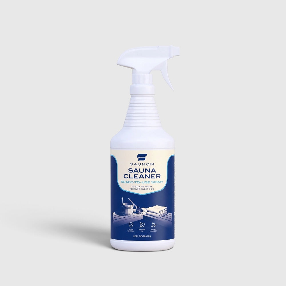 SAUNOM sauna cleaner bottle on a wooden sauna bench with warm LED lighting and forest lake view through the window