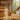 Gold aluminum sauna ladle pouring water over hot sauna stones to create loyly steam