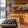 Gold SAUNOM sauna bucket and ladle beside a heater while water is poured over hot sauna stones