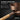 Close-up of the bamboo handle on the brown Saunom sauna bucket showing the cool-touch grip