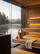 Gold sauna bucket and ladle on a wooden bench inside a modern sauna overlooking a lake