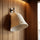 White wool sauna hat hanging on a wall hook inside a wooden sauna