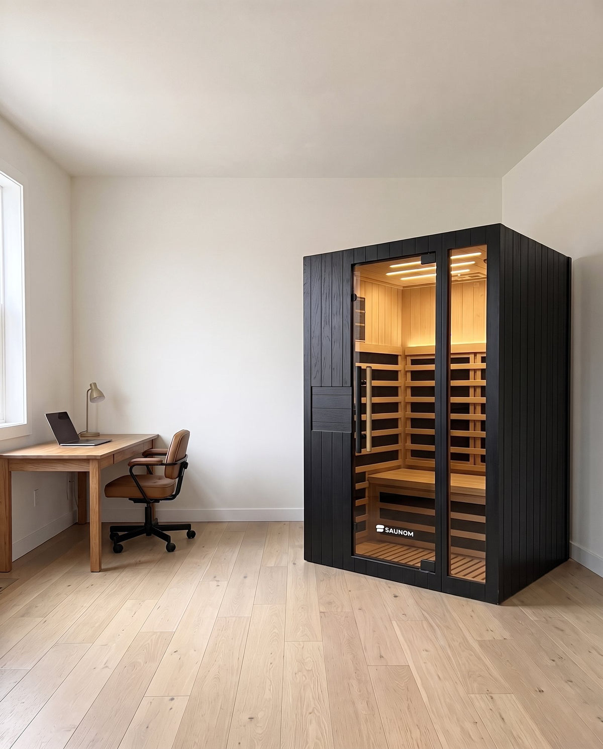 Black Saunom infrared sauna in a home office next to a desk