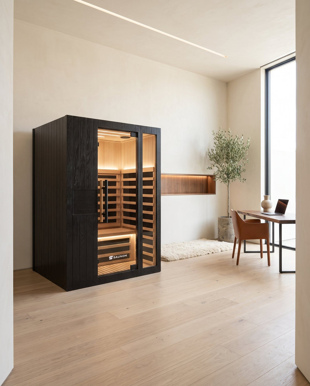 Black Saunom sauna in a home office across from a desk