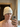 Person taking a mirror selfie while wearing a white wool sauna hat