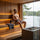 Man resting after a sauna session while wearing a grey wool sauna hat