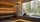 Premium sauna accessories displayed beside a modern wooden sauna with a large forest view window