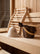 Premium sauna accessory set with wool sauna hat, wooden backrest, bucket, and ladle arranged on a sauna bench