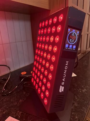 SAUNOM red light therapy panel turned on with red LEDs and digital side controls