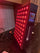 SAUNOM red light therapy panel turned on with red LEDs and digital side controls