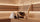 Premium sauna accessory set with wool sauna hat, wooden backrest, bucket, and ladle arranged on a sauna bench