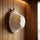 White wool bucket-style sauna hat hanging on a wall hook inside a wooden sauna