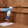 Applying Saunom ready-to-use cleaner spray to cool sauna wood