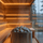 Rounded sauna stones stacked on an electric heater inside a modern wooden sauna