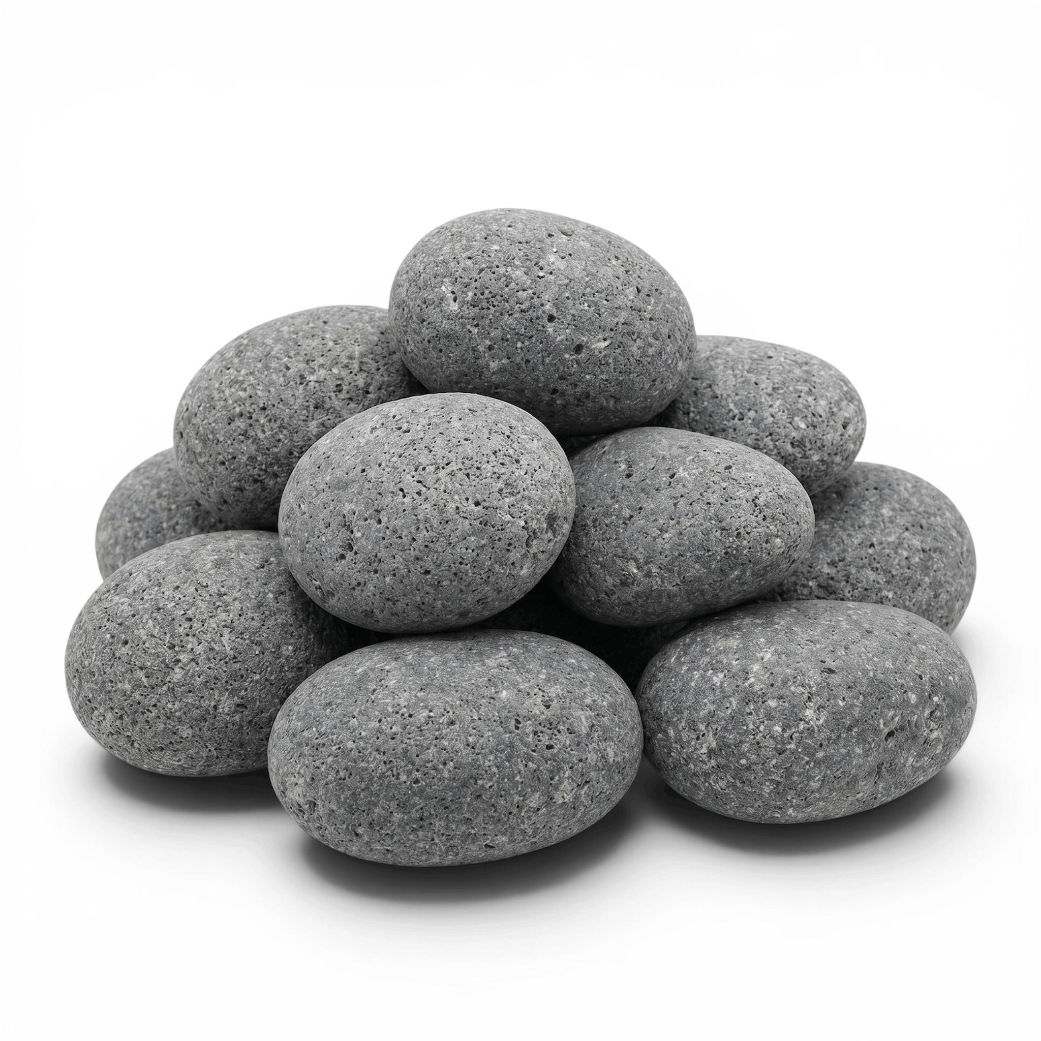 Porous grey sauna heater stones stacked on a clean white background