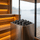 Modern wooden sauna with rounded heater stones and a misty lake view through large glass windows
