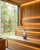 Wide view of a clean Nordic home sauna with Saunom fragrance-free sauna cleaner on the bench