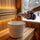 Pouring Saunom sauna cleaner concentrate into a bucket of warm water to dilute it