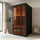 Black freestanding SAUNOM sauna room inside a modern home with glass front, warm interior lighting, and wood benches